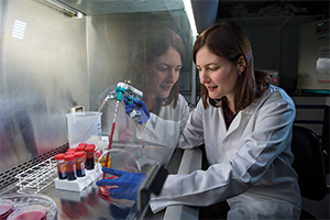 woman holding injection in lab