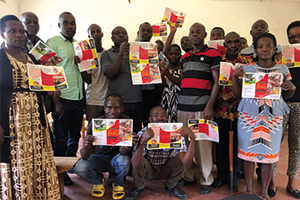 Isingiro district stakeholders with Abel Walekhwa holding the RVF flyer developed with funding from the IAA award