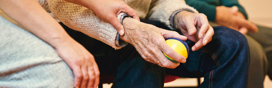 young and old hands holding ball