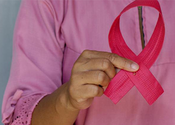Woman holds pink breast cancer awareness ribbon. Credit angiola-harry-unsplash  Credit: Angiola Harry on Unsplash