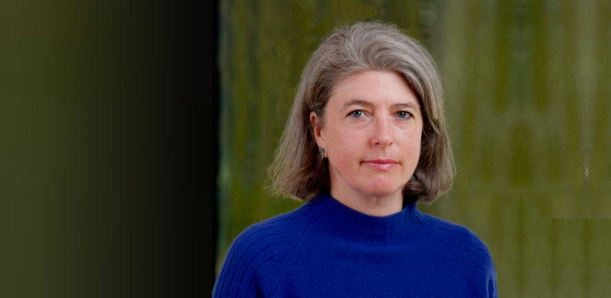 Benedicte sanson, in blue jumper, in front of blurred background of a tree
