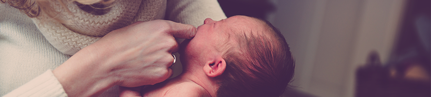 woman holding newborn baby