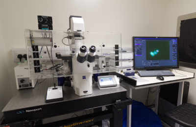 microscope on table next to computer