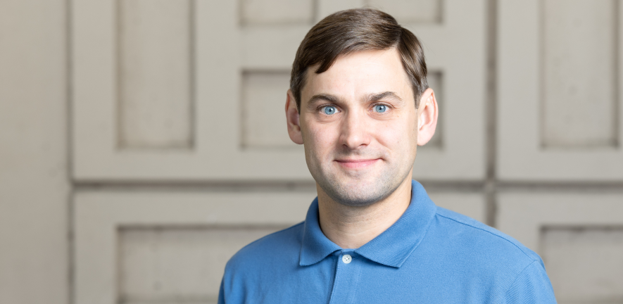 Evgeny Zatulovskiy Evgeny Zatulovkskiy, smiling, in a blue polo shirt, against a grey wall