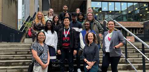 Group of students on the 2024 Postgraduate School of Life Sciences programme with the academic leads standing on a staircase outside the Museum of Zoology