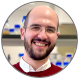 Alex Cagan, smiling, in laboratory