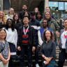 Group of students on the 2024 Postgraduate School of Life Sciences programme with the academic leads standing on a staircase outside the Museum of Zoology