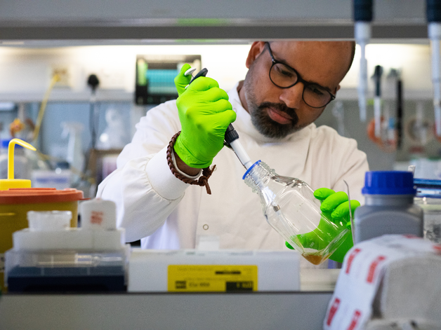 scientist holding pipette