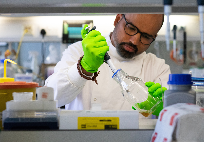 scientist holding pipette