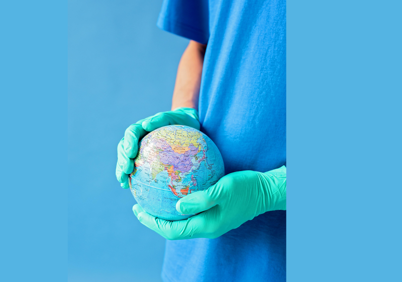 doctor holding globe between their hands