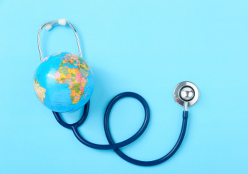 stethoscope and globe on a blue background