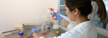 woman holding pipette in laboratory